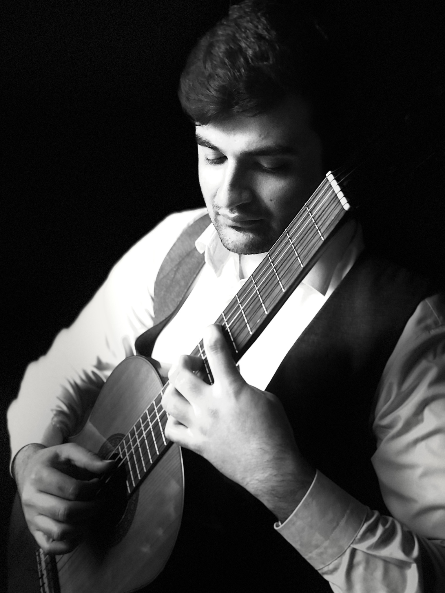 Close-up of Amin Asgari playing classical guitar