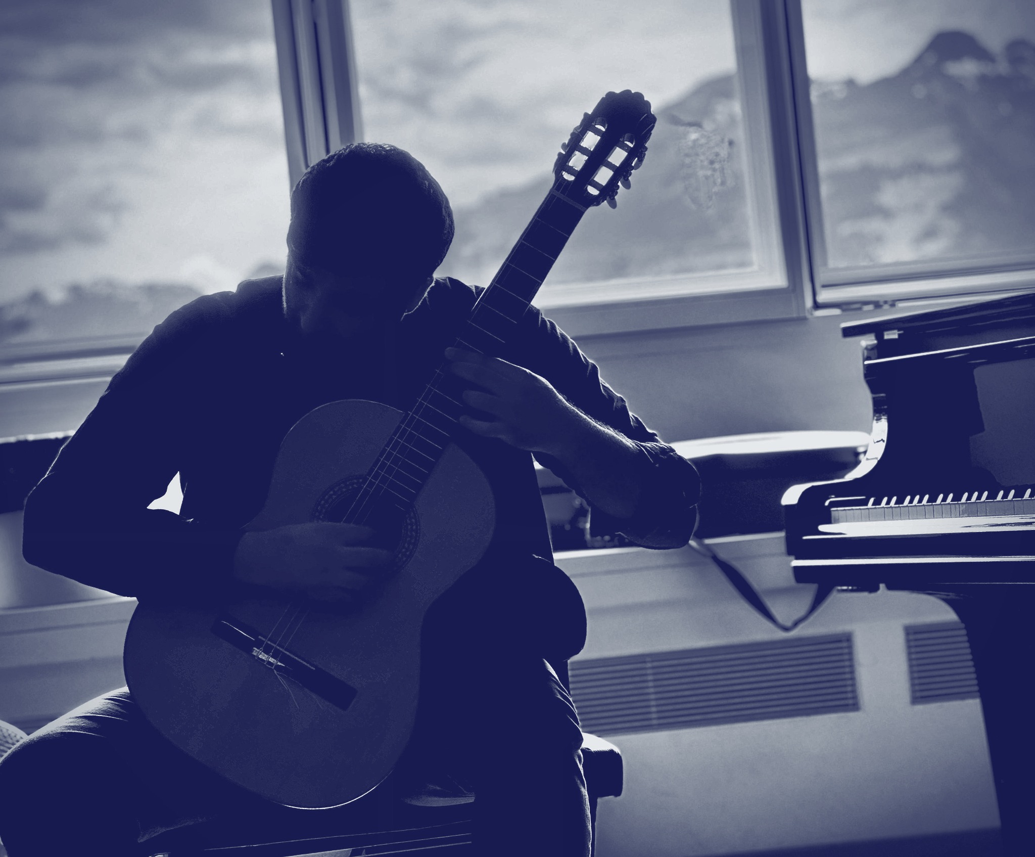 Amin Asgari playing guitar on a concert stage